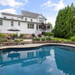 Modern Two-Story Home with Inground Pool and Stone Patio