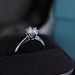 A luxury 1 carat princess cut diamond engagement ring showcased in a black velvet jewelry box.
